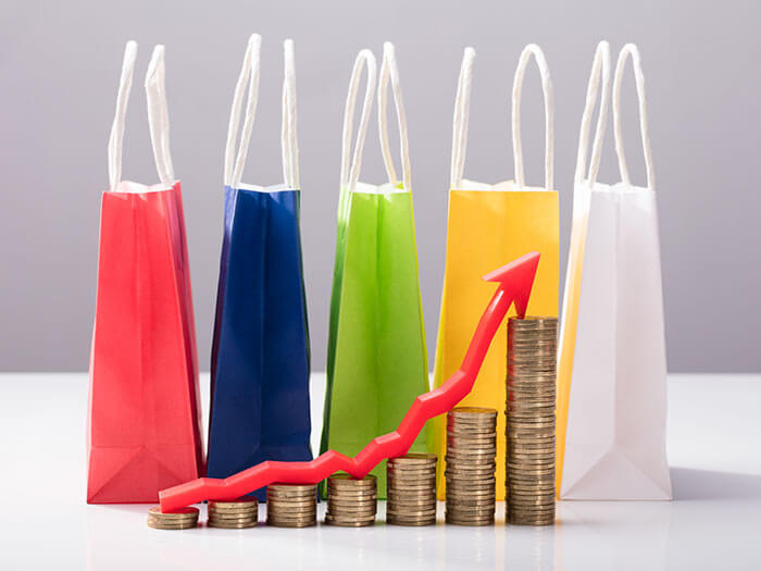 Stacked Coins In Front Of Multi Colored Shopping Bags Australian Parcel Tax