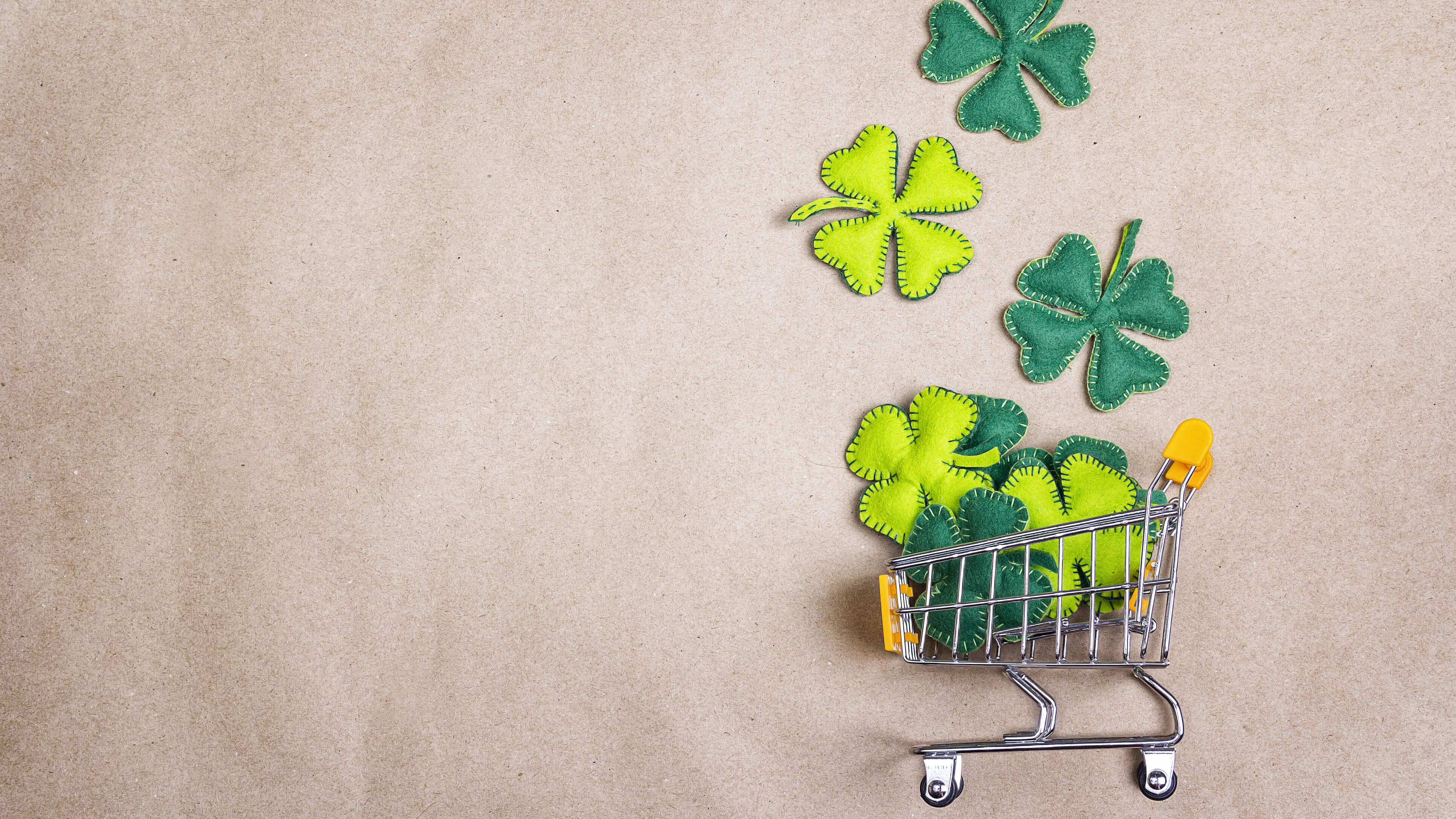 Shopping trolley with four-leaf clover on brown paper background Online Shopping Ireland