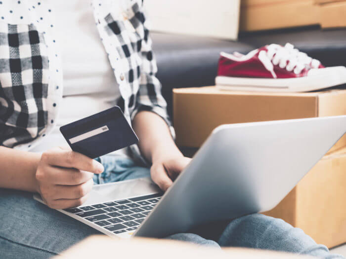 Young asian pretty girl using credit card and laptop computer fo serial returners